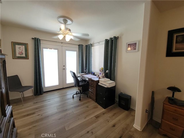 office with ceiling fan, french doors, and light hardwood / wood-style flooring