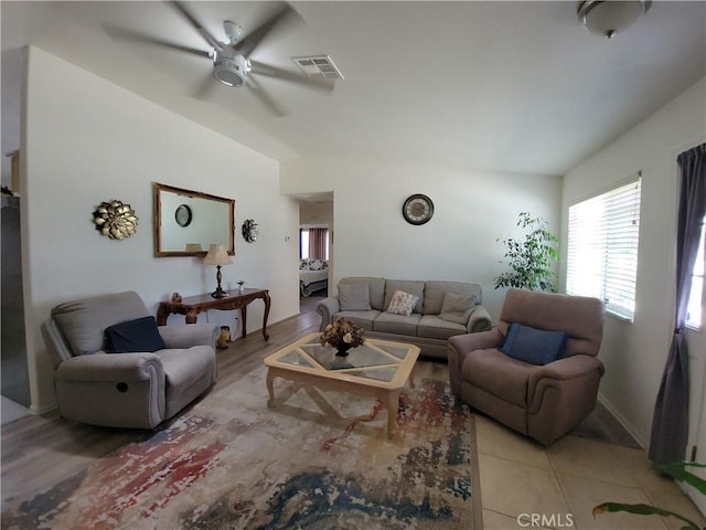 living room featuring ceiling fan and light hardwood / wood-style flooring