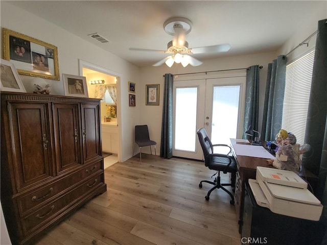 office space featuring light hardwood / wood-style floors, ceiling fan, and french doors