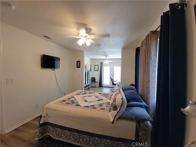 bedroom with french doors, ceiling fan, and hardwood / wood-style floors