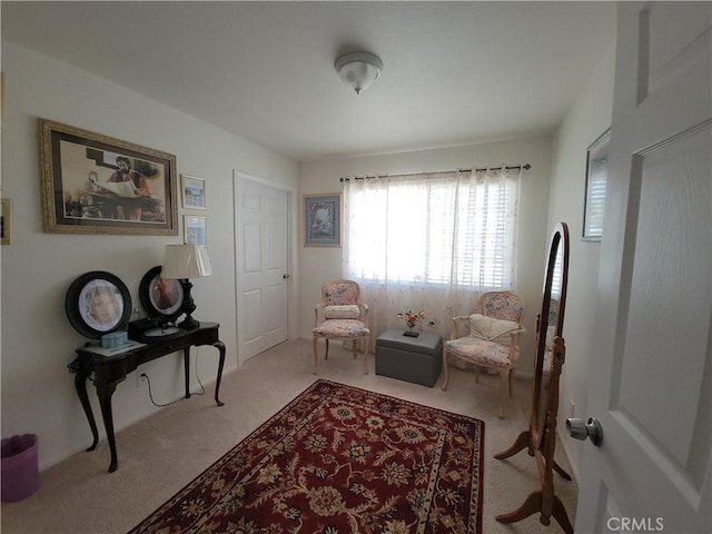 sitting room featuring light colored carpet