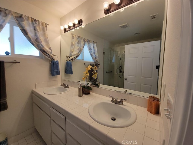 bathroom featuring vanity, tile patterned floors, and a shower with door