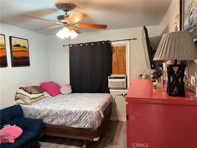 bedroom with ceiling fan, cooling unit, and hardwood / wood-style floors