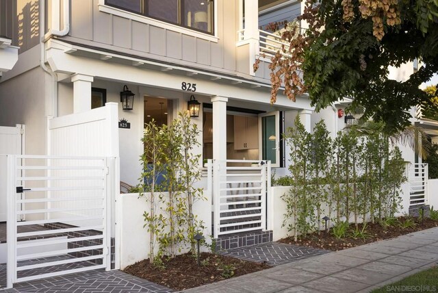 view of exterior entry with a porch