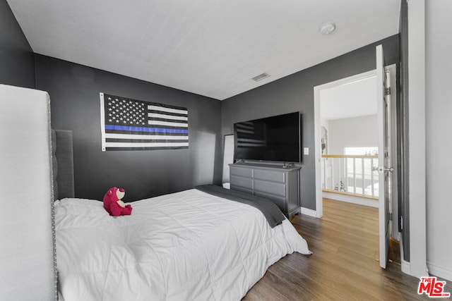 bedroom with hardwood / wood-style flooring