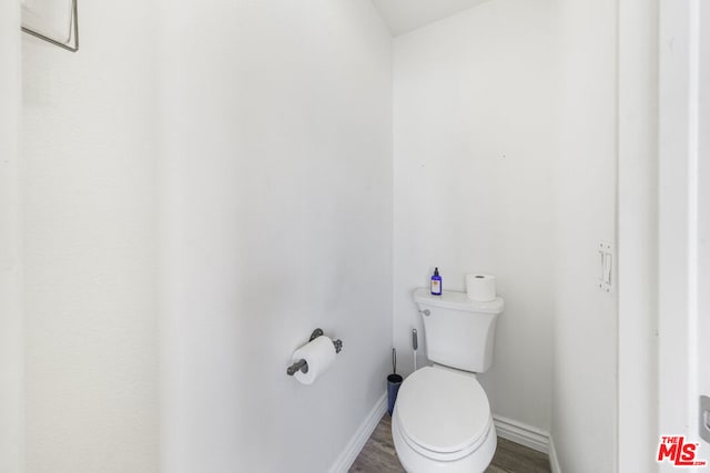 bathroom with toilet and hardwood / wood-style floors