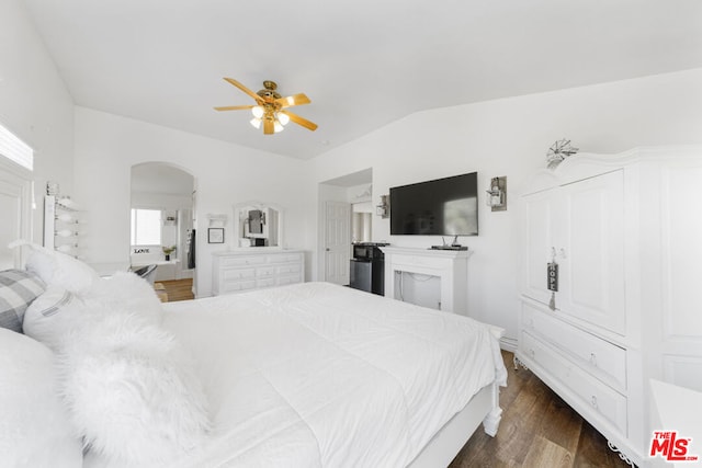 bedroom featuring ceiling fan, dark wood-type flooring, and lofted ceiling