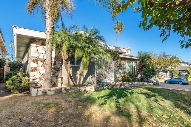 obstructed view of property featuring a front lawn