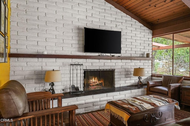 living room featuring a brick fireplace, wood ceiling, and vaulted ceiling