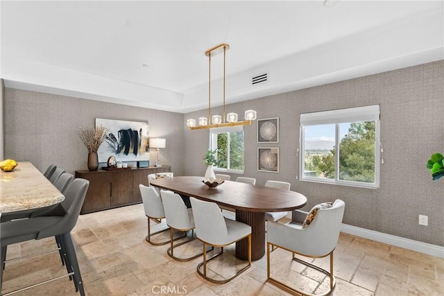 dining room with a tray ceiling