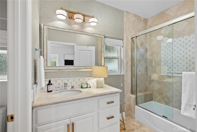 bathroom with bath / shower combo with glass door, tasteful backsplash, and vanity