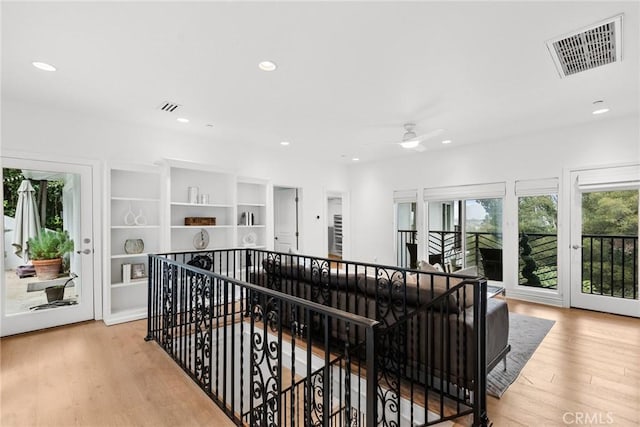 corridor with light hardwood / wood-style flooring