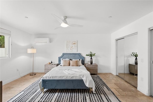 bedroom featuring ceiling fan, a closet, and an AC wall unit