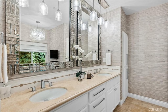 bathroom featuring an inviting chandelier, backsplash, and vanity