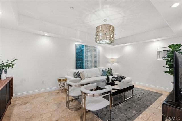 living room featuring a raised ceiling