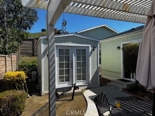 view of patio with an outbuilding and a pergola