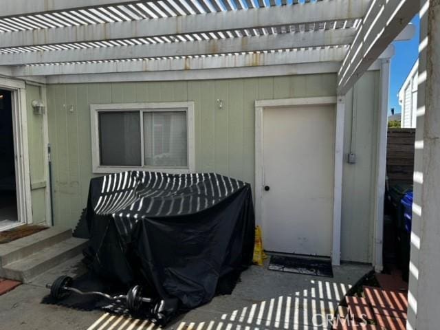 doorway to property with a pergola