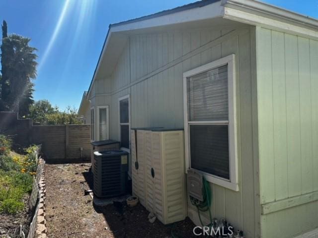 view of side of home featuring central AC