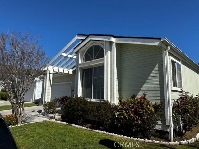 view of home's exterior featuring a garage and a lawn