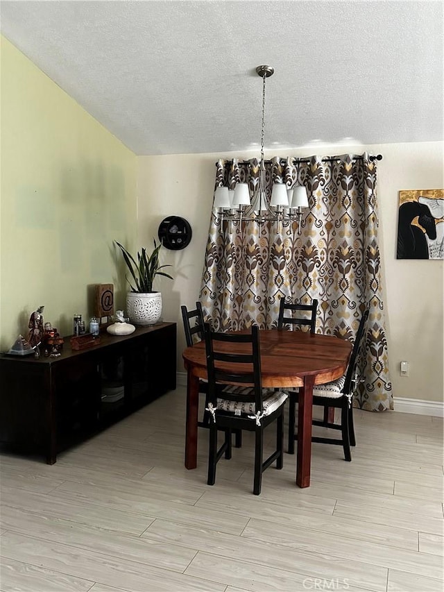 dining space featuring a textured ceiling