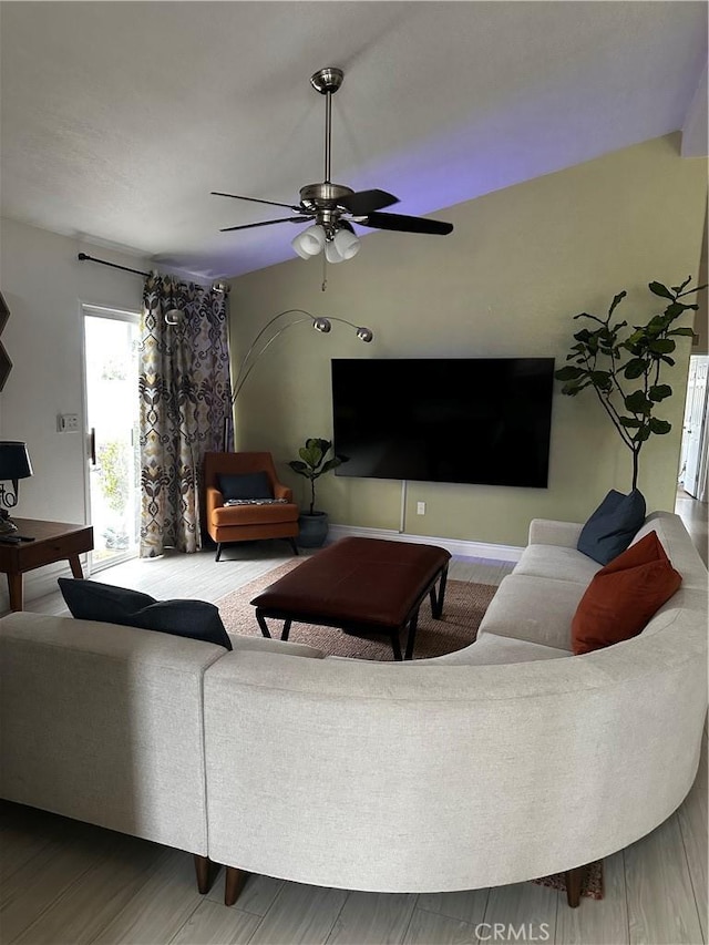 living room featuring hardwood / wood-style flooring and ceiling fan