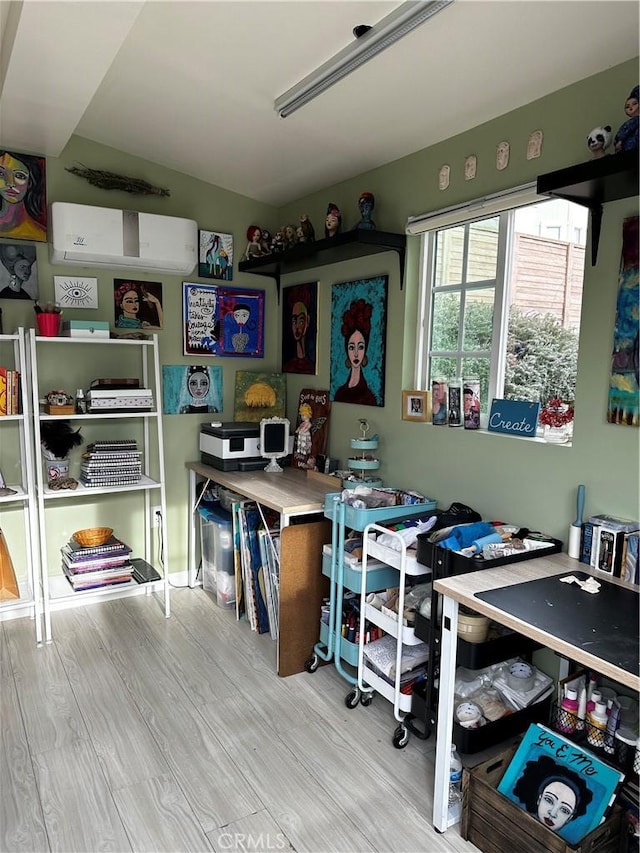 home office featuring lofted ceiling and light hardwood / wood-style flooring