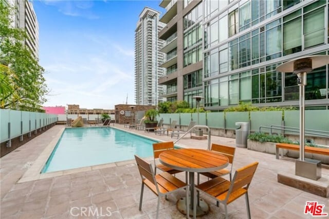 view of swimming pool featuring a patio area