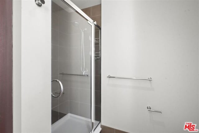 bathroom with a shower with shower door