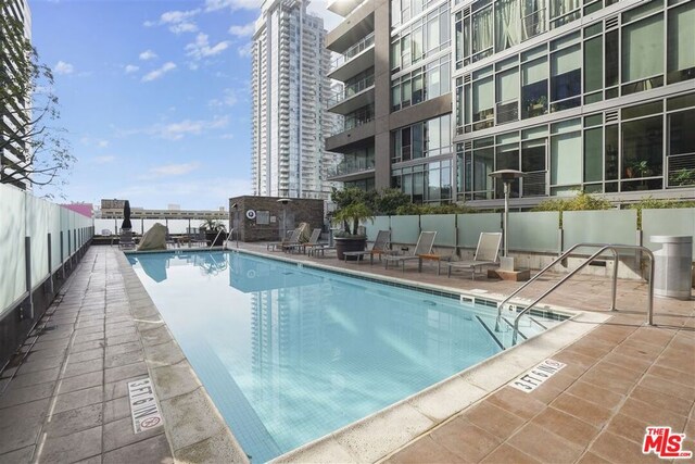 view of swimming pool featuring a patio area