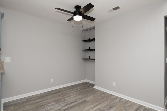 spare room with ceiling fan and hardwood / wood-style flooring