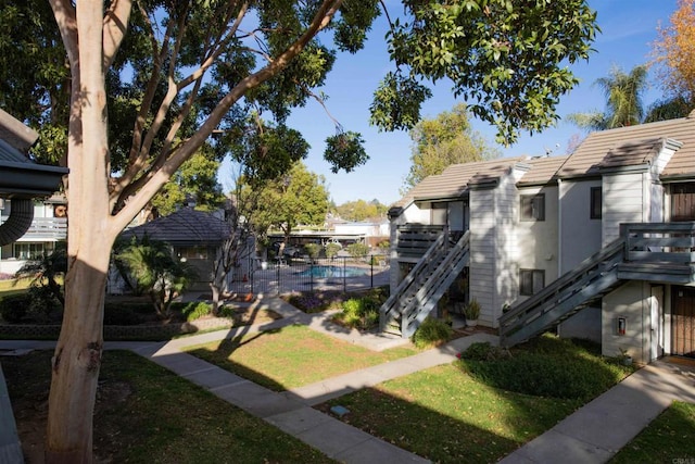 view of home's community with a yard and a swimming pool