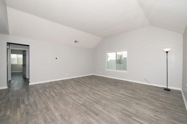 interior space with vaulted ceiling and dark wood-type flooring