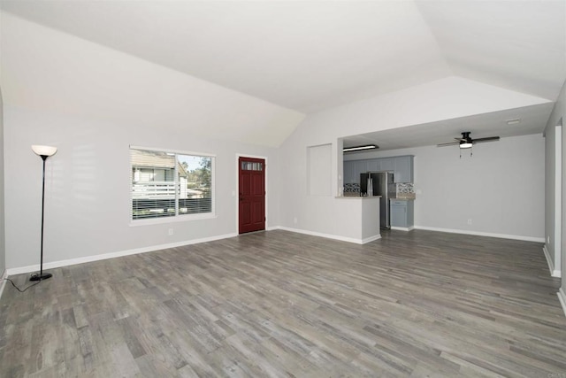 unfurnished living room featuring ceiling fan, vaulted ceiling, and hardwood / wood-style flooring