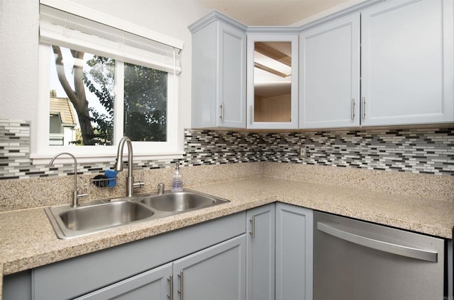 kitchen with gray cabinets, dishwasher, tasteful backsplash, and sink