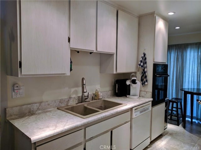 kitchen with white dishwasher, sink, and black oven