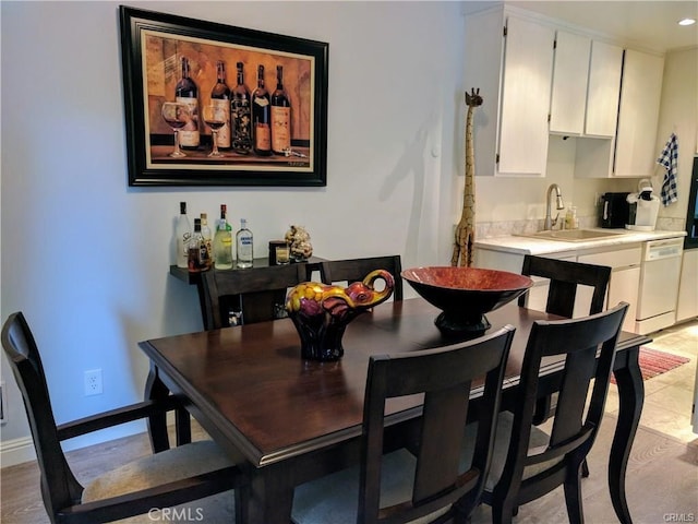 dining space with wet bar and light hardwood / wood-style floors