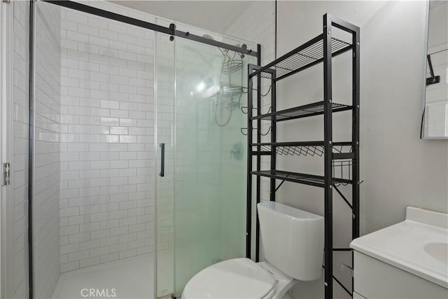 bathroom featuring walk in shower, vanity, and toilet