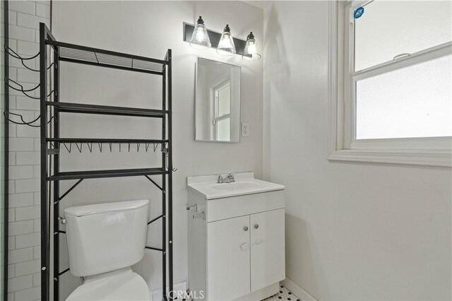 bathroom featuring toilet and vanity