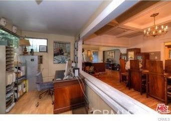 office space with light hardwood / wood-style flooring and a notable chandelier