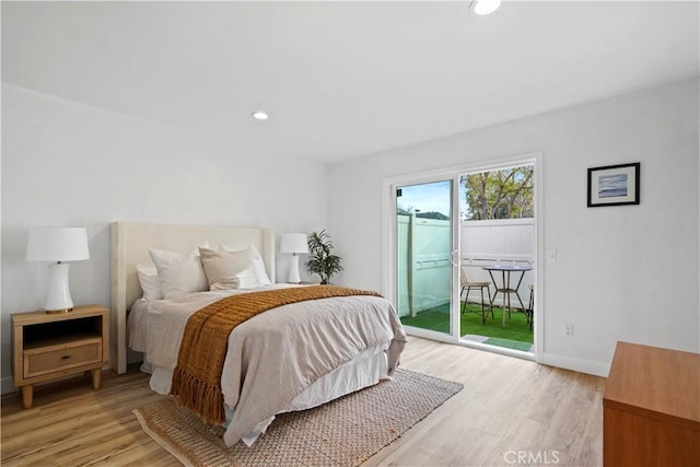 bedroom featuring access to exterior and light hardwood / wood-style flooring