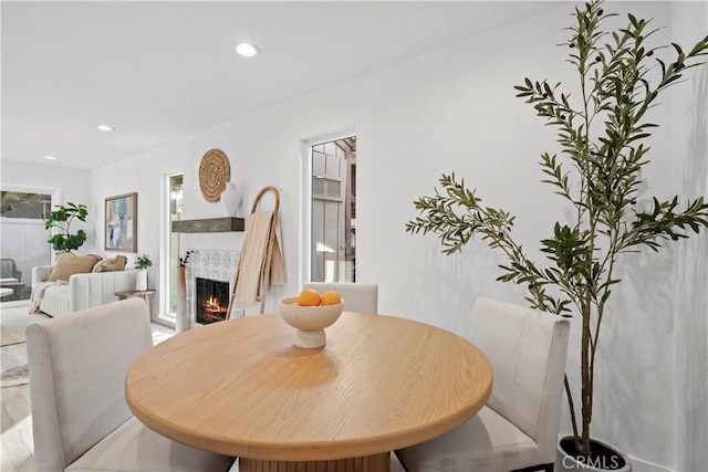 dining room featuring a tiled fireplace