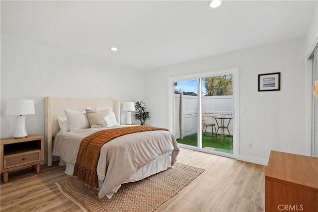 bedroom with light hardwood / wood-style flooring and access to outside