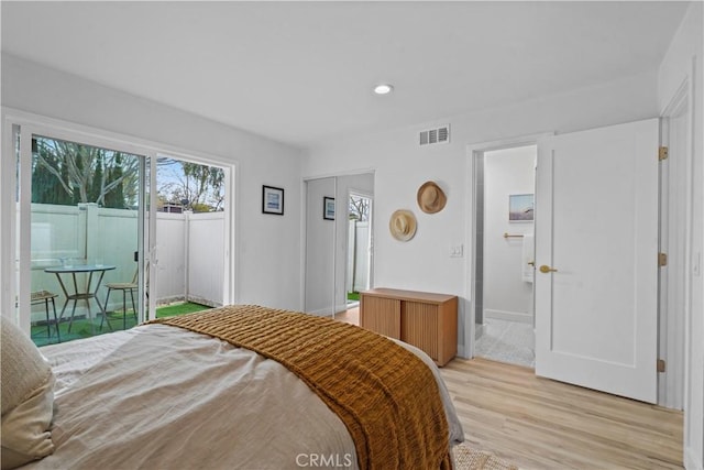 bedroom featuring access to exterior and light hardwood / wood-style floors