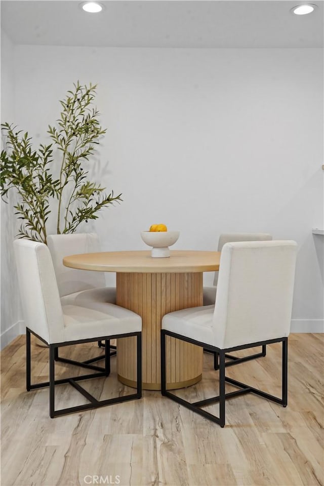 dining space with light hardwood / wood-style floors