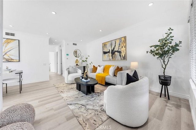 living room featuring light wood-type flooring and crown molding