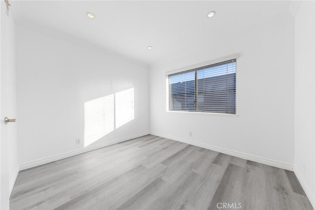 spare room featuring light hardwood / wood-style flooring