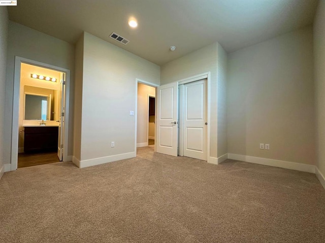 unfurnished bedroom featuring a closet and carpet