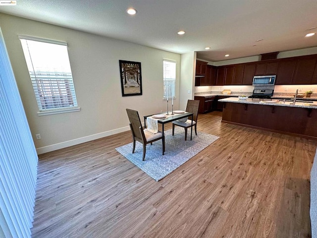 dining area featuring light hardwood / wood-style floors and sink