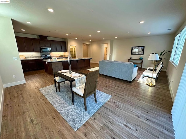 dining space featuring light hardwood / wood-style floors and sink