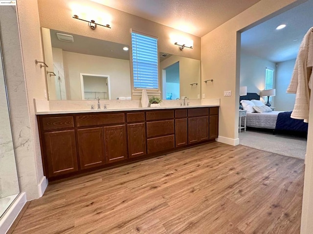 bathroom featuring vanity, a shower with door, and hardwood / wood-style flooring